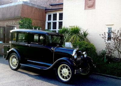 Old fashioned wedding car parked outside The Birch Hotel