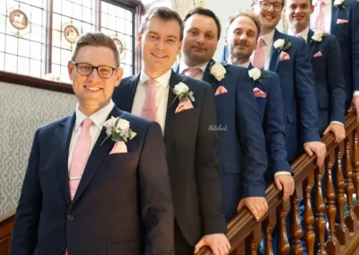 Groom and Groomsmen in a line ascending up the stairs
